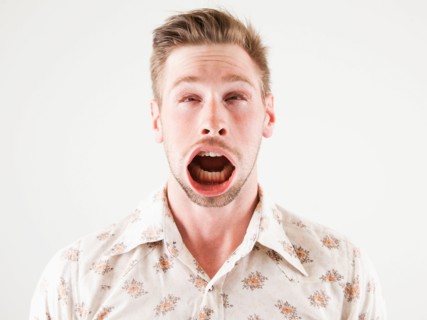 Studio shot of man with windblown mouth. Photo : Jessica Peterson