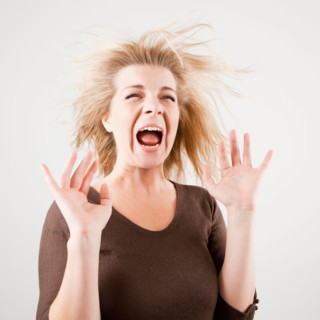 Studio shot of young woman screaming. Photo : Jessica Peterson