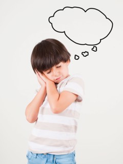 Studio shot of boy (6-7) with thought bubble. Photo: Jessica Peterson