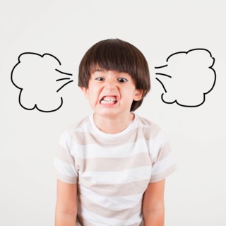 Studio shot of boy (6-7) with smoke puffs coming out of ears. Photo: Jessica Peterson