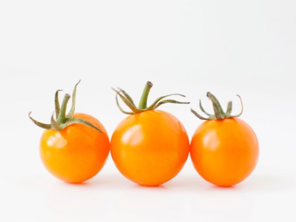 Studio Shot of three Cherry Tomatoes. Photo : Jessica Peterson