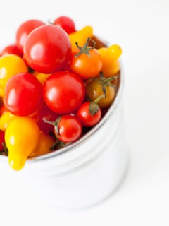 Studio Shot of Cherry Tomatoes in plastic container. Photo : Jessica Peterson
