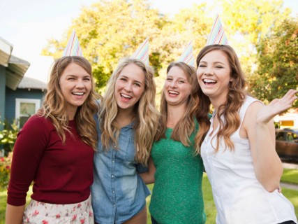 Portrait of four friends wearing party hat. Photo : Jessica Peterson