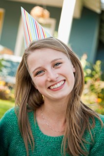 Portrait of young woman in party hat. Photo : Jessica Peterson