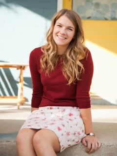 Portrait of young woman sitting on porch. Photo : Jessica Peterson