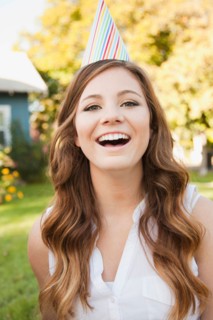 Portrait of young woman in party hat. Photo : Jessica Peterson