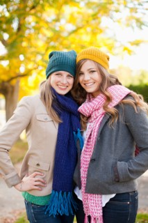 Portrait of two young women wearing hats and scarves. Photo: Jessica Peterson