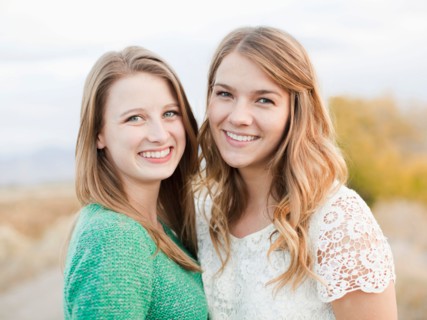 Portrait of two young women cheek to cheek. Photo : Jessica Peterson