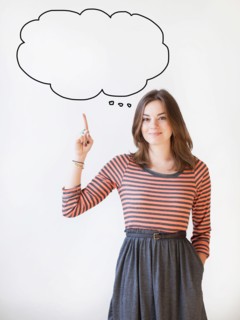 Studio shot young woman pointing up on thought bubble. Photo : Jessica Peterson