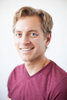 Studio Shot of young adult man expressing happiness. Photo : Jessica Peterson