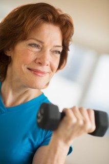 Senior woman lifting weights.