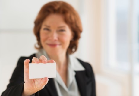 Portrait of businesswoman showing blank business card.