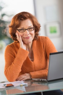 Senior woman working on laptop at home.