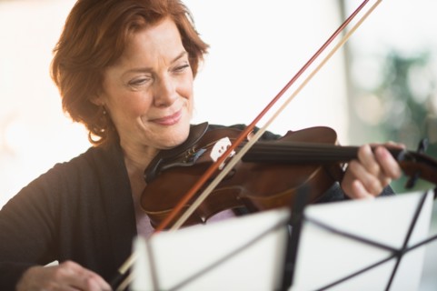Senior woman playing violin.