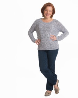 Studio shot of senior woman smiling.