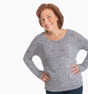 Studio shot of senior woman smiling.