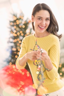 Woman decorating christmas tree.