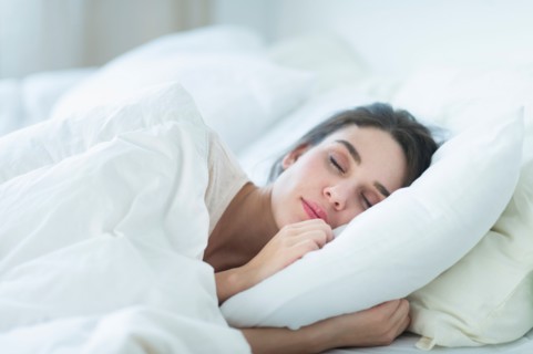 Woman sleeping in bed.