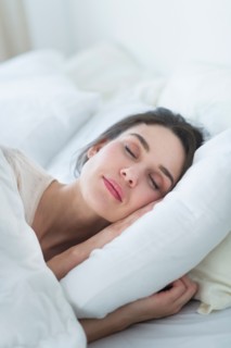 Woman sleeping in bed.