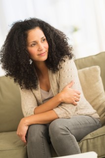 Portrait of mid adult woman sitting on sofa.