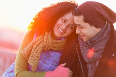 Portrait of happy couple embracing at sunset.