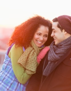 Portrait of happy couple embracing at sunset.