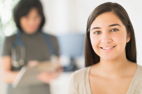 Teenage girl (16-17) in doctor's office.