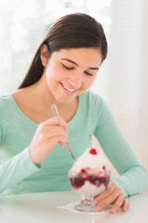Teenage girl (16-17) eating ice-cream.