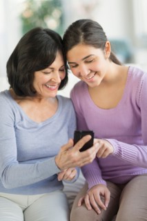 Grandmother and granddaughter (16-17) with mobile phone.