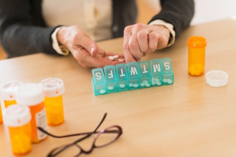 Senior woman dozing pills.