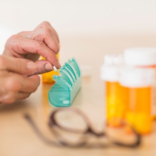 Senior woman dozing pills.