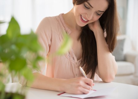 Young woman writing letter