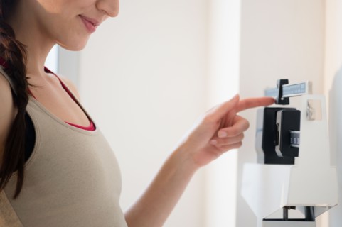 Young woman on scales