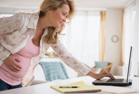 Pregnant woman using laptop