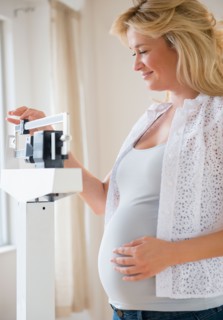 Pregnant woman on weighting scales