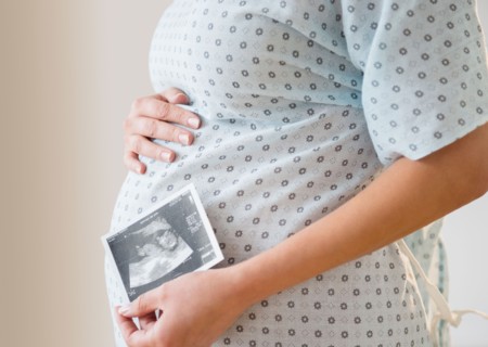 Pregnant woman with ultrasound scan of fetus