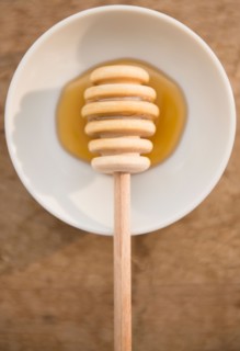 Studio shot of honey on saucer