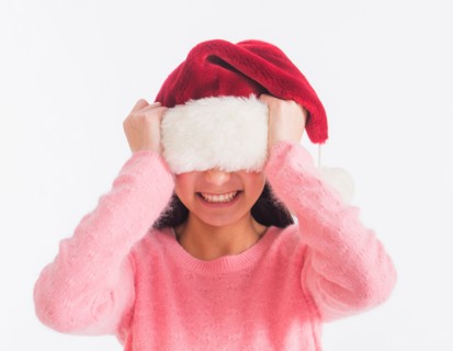 Portrait of teenage girl (16-17 years) wearing santa hat