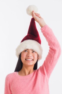 Portrait of teenage girl (16-17 years) wearing santa hat