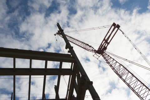 Upward view of crane and construction