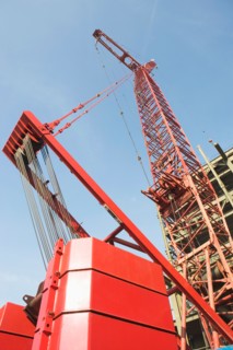 Low angle view of crane and building under construction