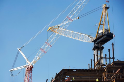 Low angle view of crane and construction frame