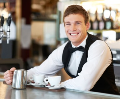 Portrait of barista holding milk jug