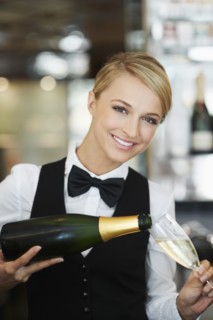 Waitress pouring champagne into champagne flute