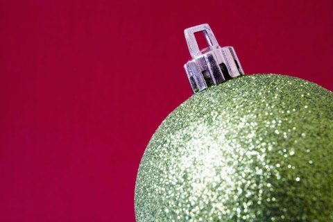 Close up of shiny Christmas decoration on red background