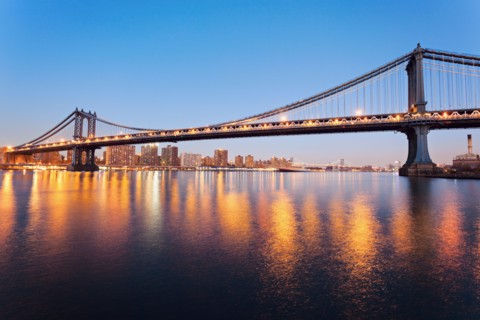 Cityscape with bridge lights reflected in water