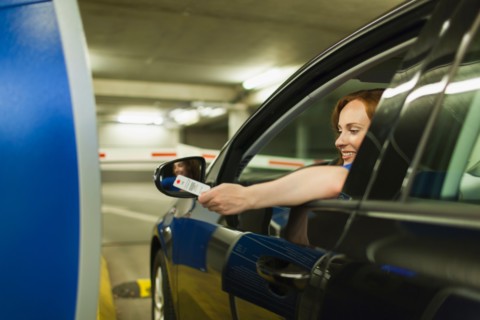 Young woman parking car