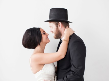 Studio Shot portrait of bride and groom smiling face to face