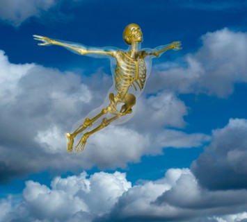 Human skeleton flying amidst clouds