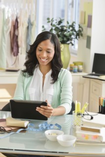 Female entrepreneur using digital tablet.